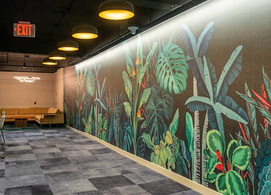 a large mural of plants on the wall of a hall at Textile Apartments, Cincinnati