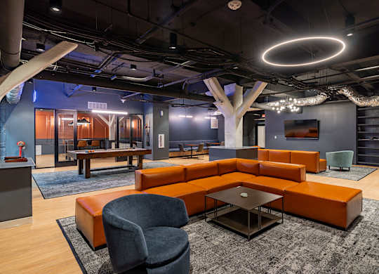 a lounge area with couches and chairs and a ping pong table at Textile Apartments, Cincinnati