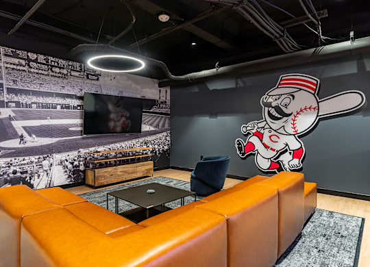 a wall mural of a baseball player in a living room at Textile Apartments, Ohio, 45202