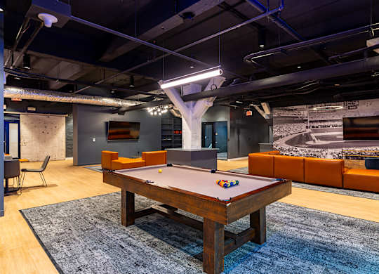 a game room with a pool table and a tv at Textile Apartments, Cincinnati, Ohio