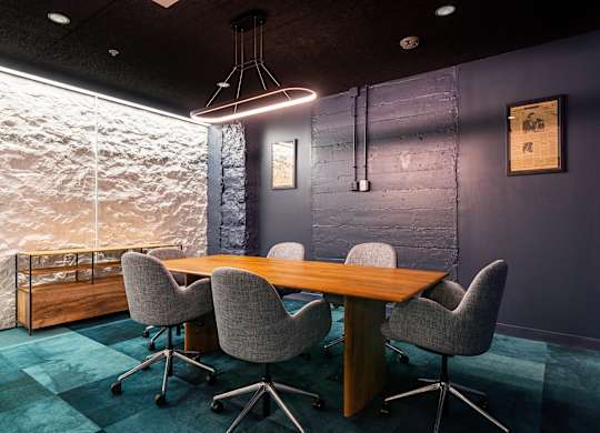 a conference room with a wooden table and chairs at Textile Apartments, Cincinnati, Ohio