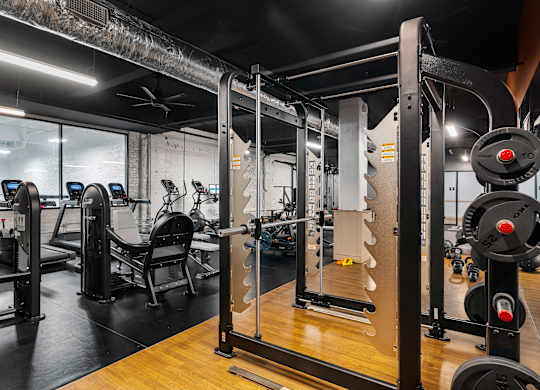 a fitness room with weights and other exercise equipment at Textile Apartments, Cincinnati, 45202