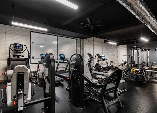 a gym with treadmills and other exercise equipment at Textile Apartments, Cincinnati