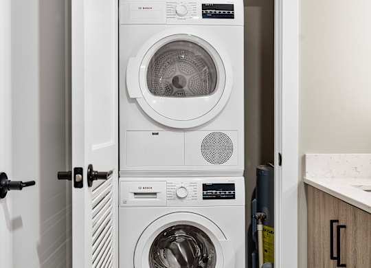 a white washer and dryer in a small laundry room at Textile Apartments, Ohio, 45202