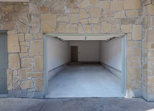 a garage with an open door and a concrete floor at Discovery at Craig Ranch, McKinney, TX, 75070