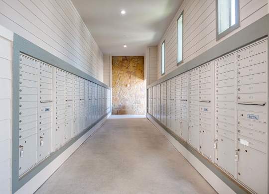 a row of lockers in a long room with a stone wall at Discovery at Craig Ranch, McKinney, Texas