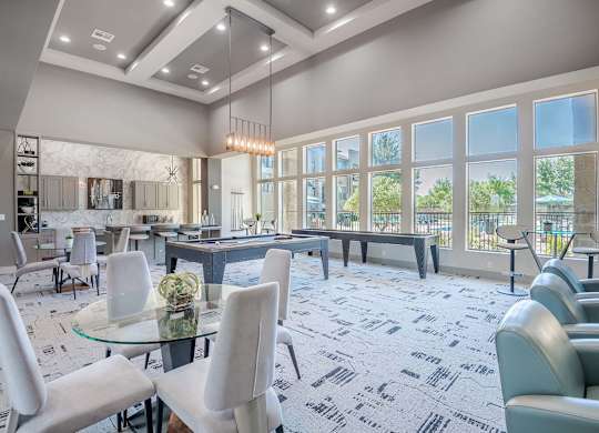 a gathering room with tables and chairs and large windows at Discovery at Craig Ranch, Texas