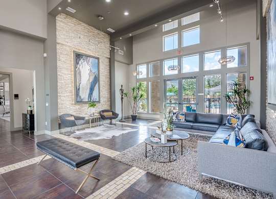 a living room with couches and tables and large windows at Discovery at Craig Ranch, McKinney, Texas
