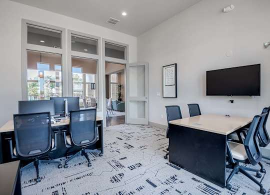 a conference room with a table and chairs and a television at Discovery at Craig Ranch, McKinney, 75070