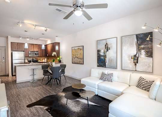 a living room and kitchen with a couch and a table at Discovery at Craig Ranch, McKinney, 75070