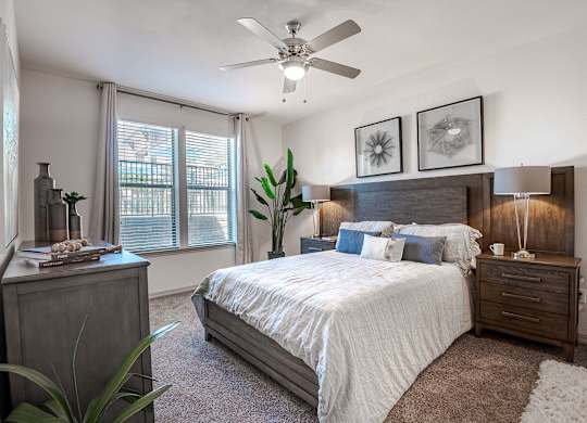 a bedroom with a bed and a ceiling fan at Discovery at Craig Ranch, McKinney, TX