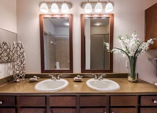 a bathroom with two sinks and two mirrors at Discovery at Craig Ranch, McKinney, 75070