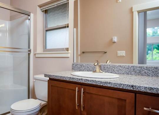 a bathroom with a sink toilet and shower