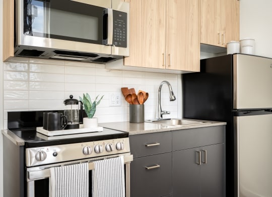 a kitchen with stainless steel appliances and wooden cabinets