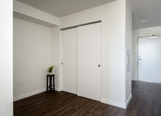 an empty room with white walls and a closet