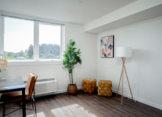 Room with large window, air conditioner, desk and chair