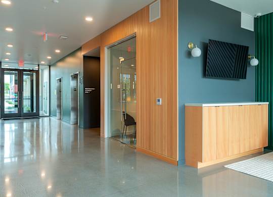 A reception area with a wooden desk and a blue wall.