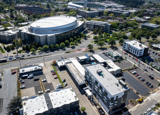 an aerial view of a city with buildings and a stadium