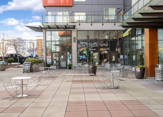 a patio with tables and chairs outside of a building
