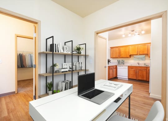 a home office with a laptop computer sitting on top of a desk
