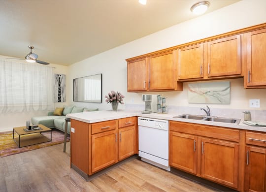 a kitchen and living room with wooden cabinets and white appliances