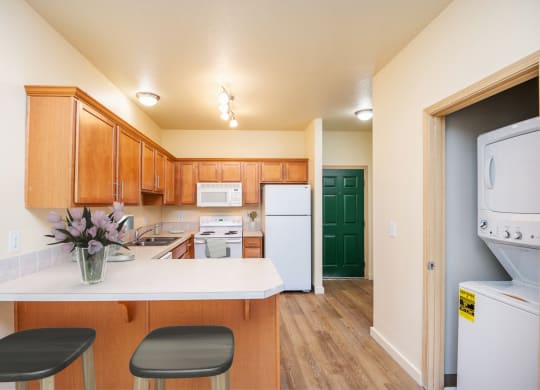 a kitchen with white appliances and wooden cabinets