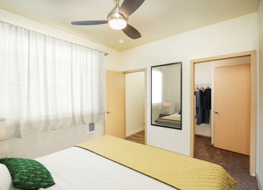 a bedroom with a large bed and a ceiling fan