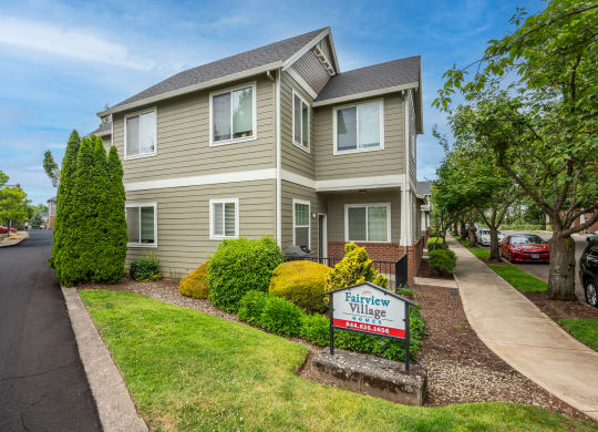 a house with a for sale sign in front of it