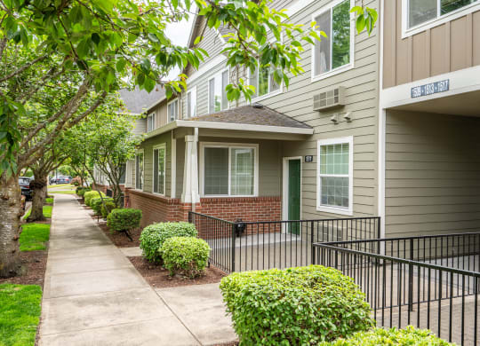 a sidewalk in front of an apartment building