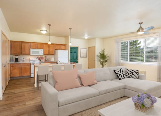 a living room and kitchen with a couch and a table