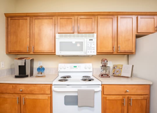 a kitchen with a stove microwave and cabinets