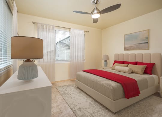 a bedroom with a bed and a ceiling fan