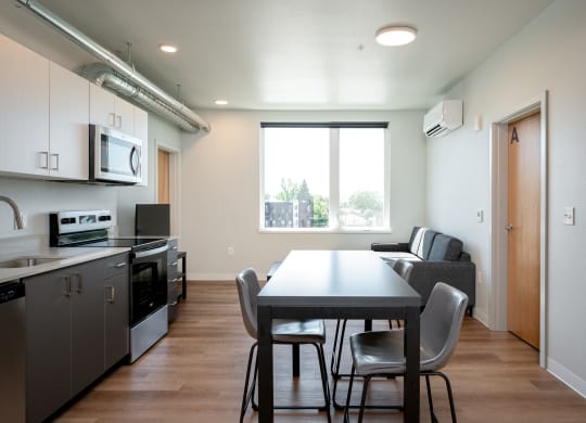 a kitchen and dining room with a table and chairs
