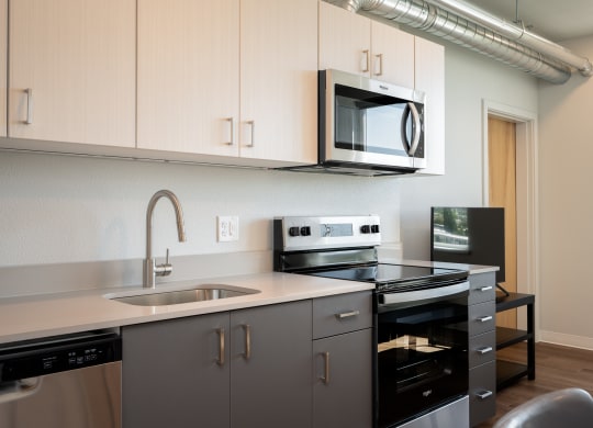 an empty kitchen with a sink and a microwave
