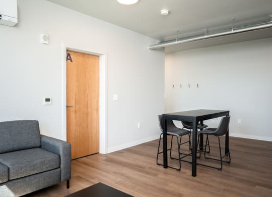 a living room with a couch and a table and a chair