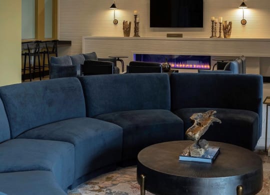 a living room with blue couches and a coffee table