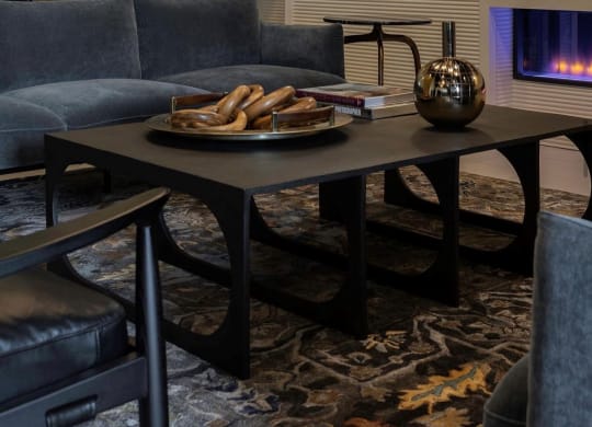 a living room with couches a table and a fireplace