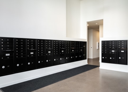 a large filing cabinet in a white room with a wall of lockers