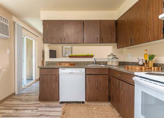 Model Kitchen with wood cabinetry and white appliances
