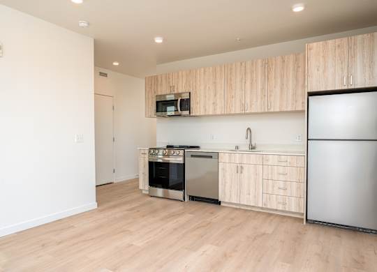 A kitchen with wooden cabinets and stainless steel appliances.