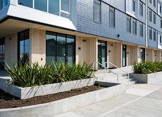 A modern building with a white overhang and large windows.