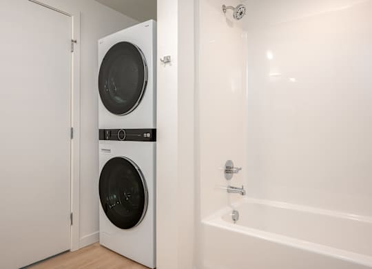 A white washing machine and dryer in a small laundry room.