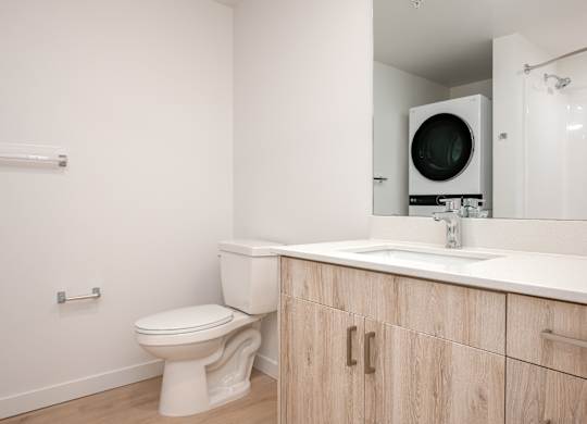 A white toilet sits next to a sink in a bathroom.
