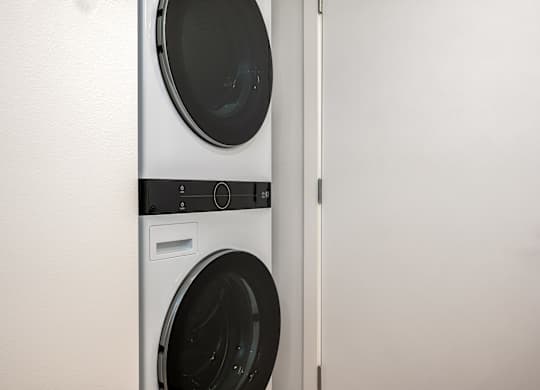 A white washing machine and dryer in a laundry room.