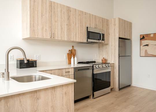 A kitchen with wooden cabinets and stainless steel appliances.
