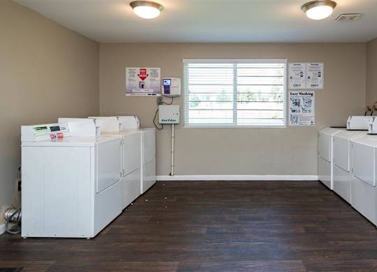 A laundry room with washers and dryers.