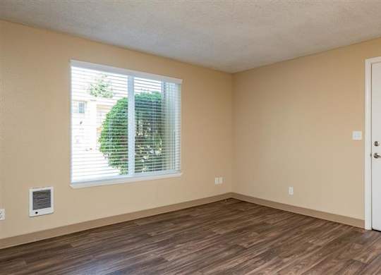 A room with a white door and a window with blinds.