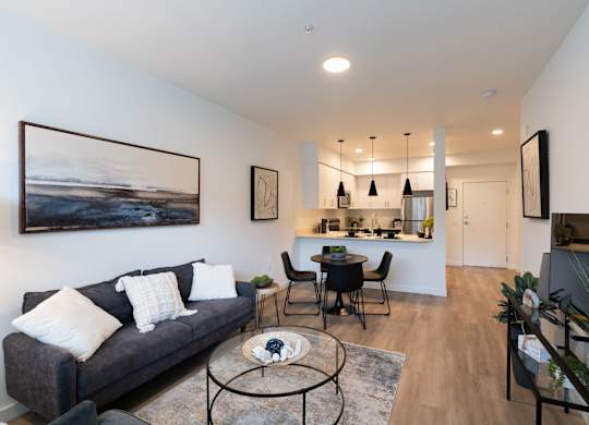 A living room with a grey couch and a coffee table.
