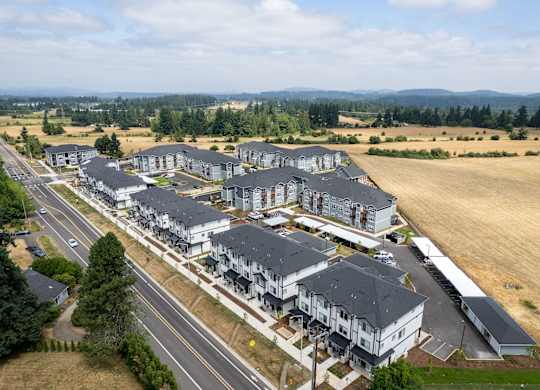 A large housing development with multiple buildings and a road running through it.