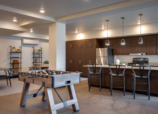 a large kitchen with a foosball table in the center of it